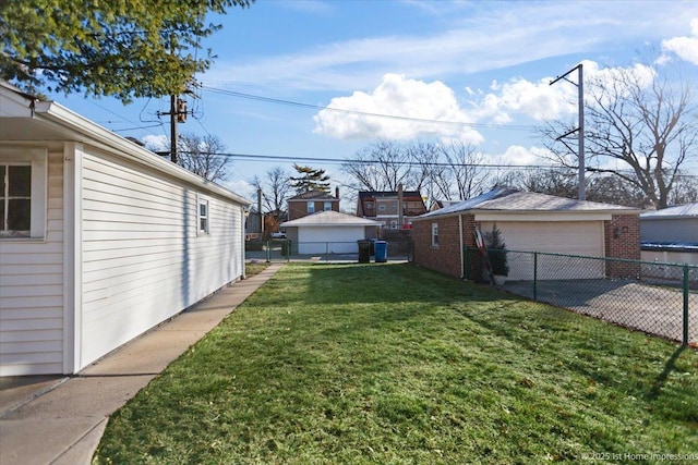 view of yard featuring a garage and an outbuilding