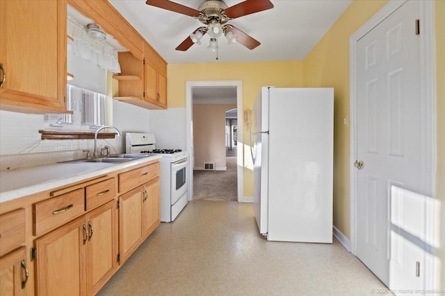 kitchen with ceiling fan, a wealth of natural light, sink, and white appliances