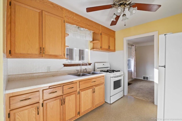 kitchen with ceiling fan, sink, plenty of natural light, and white appliances