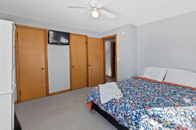 bedroom with ceiling fan and light colored carpet