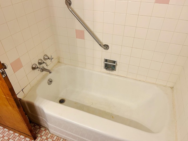 bathroom featuring tiled shower / bath combo and tile patterned floors