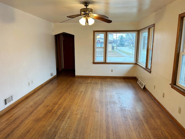 spare room with hardwood / wood-style floors and ceiling fan