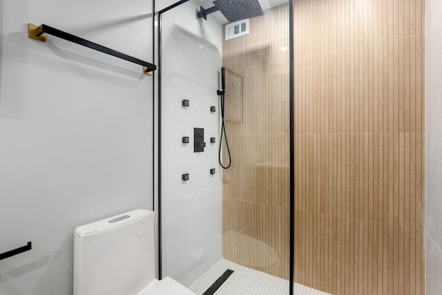 bathroom featuring toilet and walk in shower