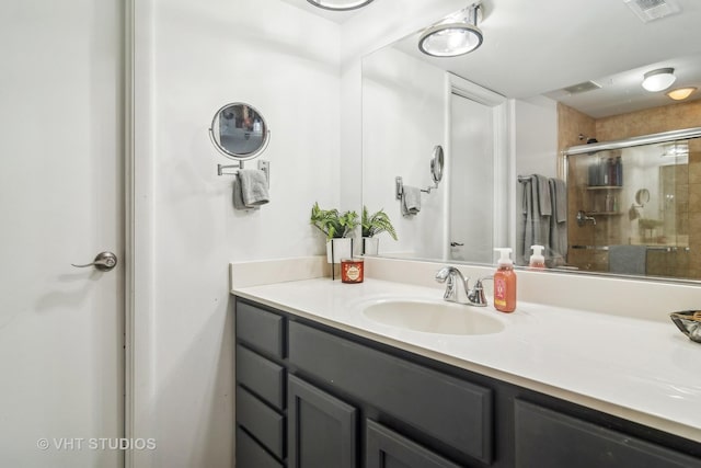 bathroom with vanity and an enclosed shower