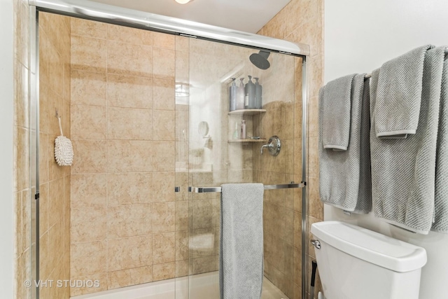 bathroom with an enclosed shower and toilet