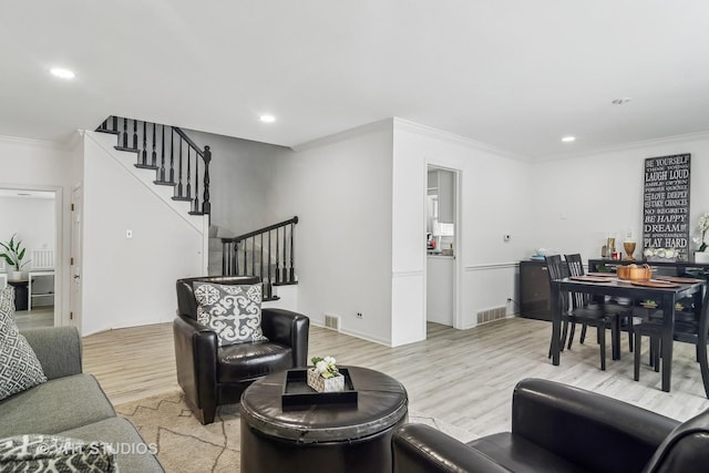 living room with crown molding and wood-type flooring