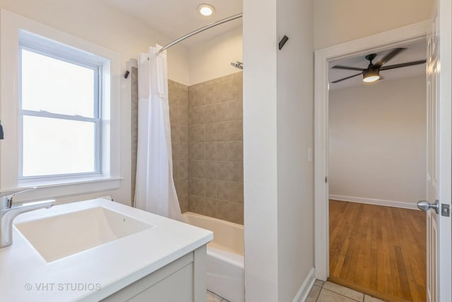 bathroom featuring shower / tub combo with curtain, a healthy amount of sunlight, tile patterned flooring, and sink