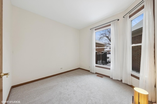 empty room featuring light carpet