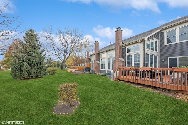 view of yard featuring central AC and a deck