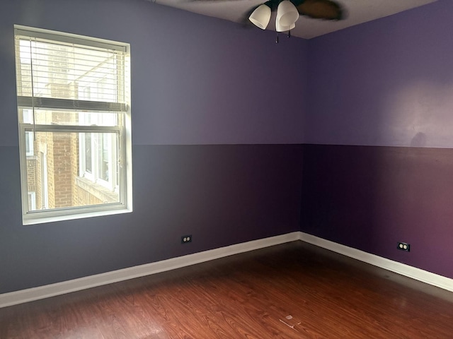 empty room featuring ceiling fan, hardwood / wood-style floors, and vaulted ceiling