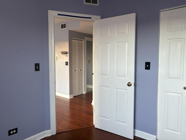 unfurnished bedroom with dark hardwood / wood-style floors