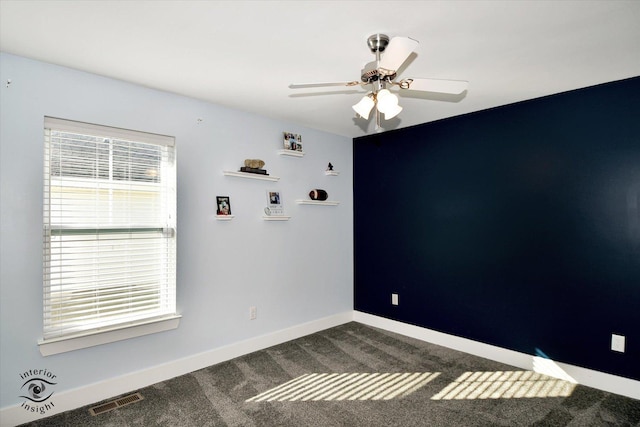 spare room featuring carpet flooring and ceiling fan