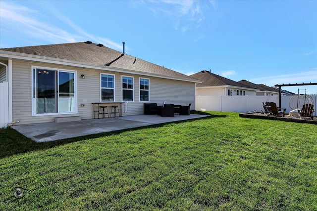 rear view of house featuring a lawn and a patio area