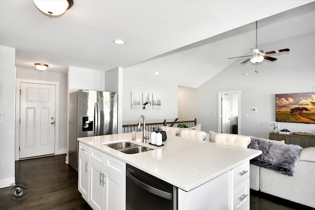 kitchen featuring dishwasher, vaulted ceiling, an island with sink, white cabinets, and sink