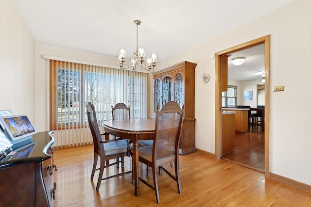 dining space with an inviting chandelier and light wood-type flooring