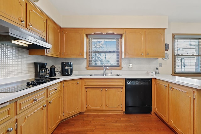 kitchen with hardwood / wood-style flooring, sink, decorative backsplash, and black appliances