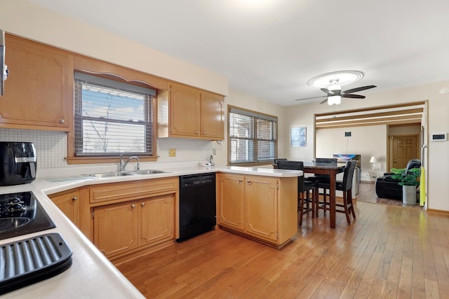 kitchen with sink, light hardwood / wood-style flooring, dishwasher, tasteful backsplash, and kitchen peninsula