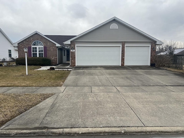 single story home featuring a garage, brick siding, concrete driveway, fence, and a front yard