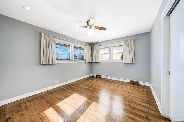 empty room featuring ceiling fan and dark hardwood / wood-style flooring