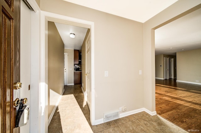 hallway featuring tile patterned flooring