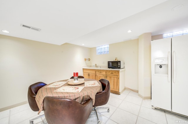 dining space with sink and light tile patterned flooring