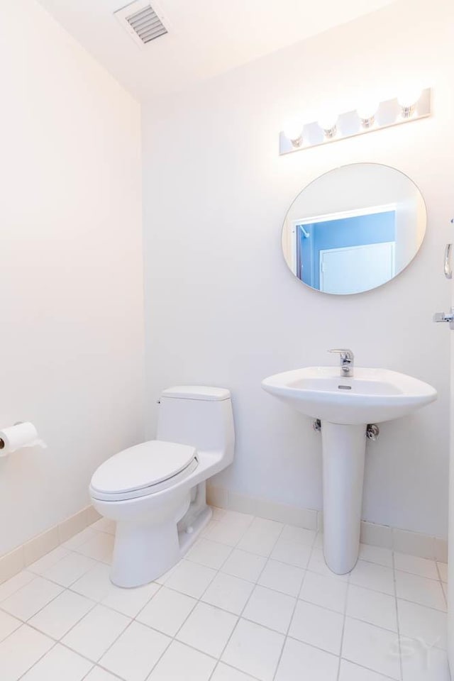 bathroom featuring toilet and tile patterned floors