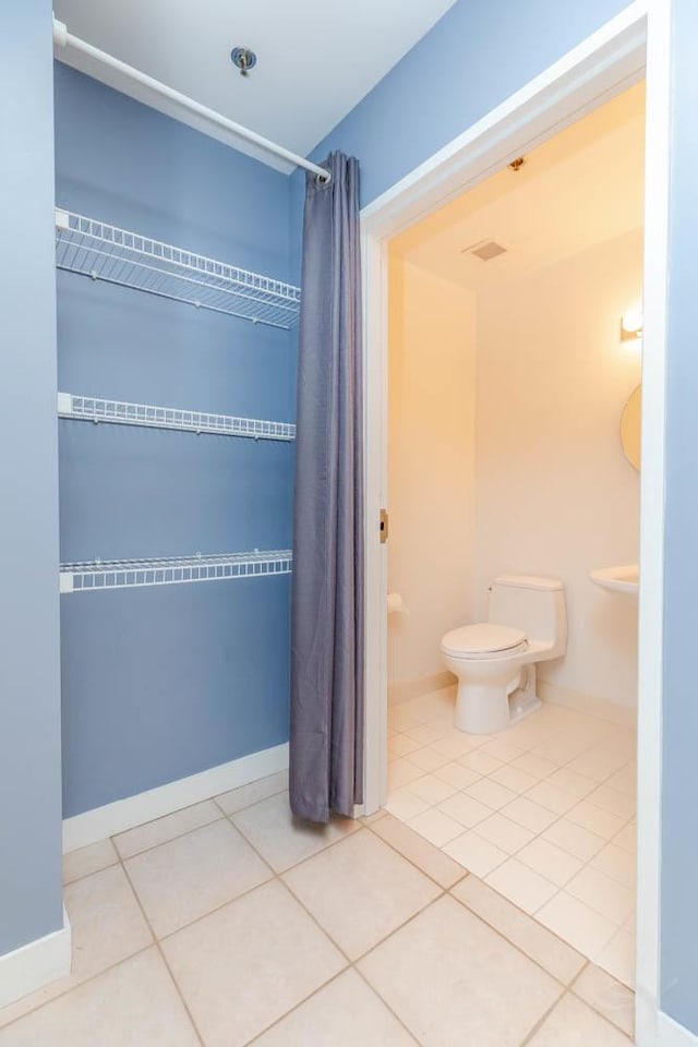 bathroom with tile patterned floors and toilet