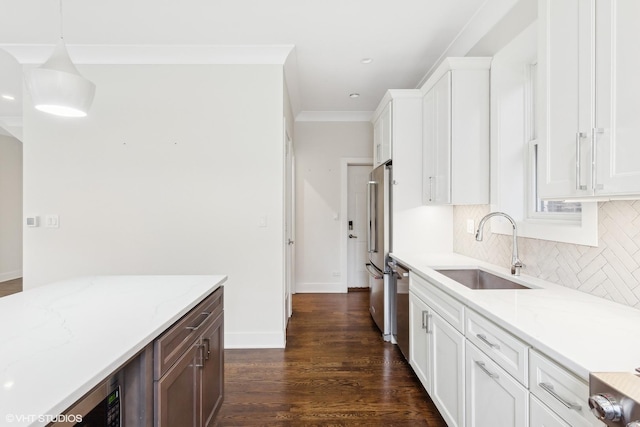 kitchen with sink, decorative light fixtures, white cabinetry, and light stone counters