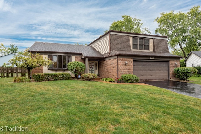 view of front of house with a front yard and a garage