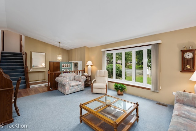 living room featuring vaulted ceiling and carpet flooring