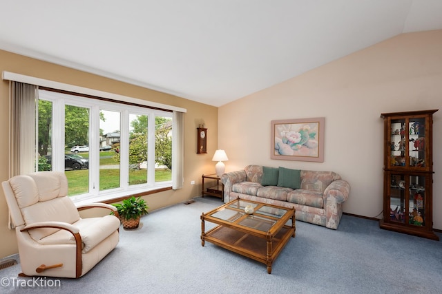 living room with lofted ceiling, carpet flooring, and plenty of natural light