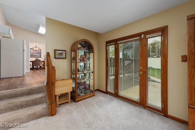 doorway to outside featuring light carpet