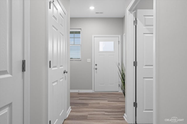 corridor with light hardwood / wood-style floors