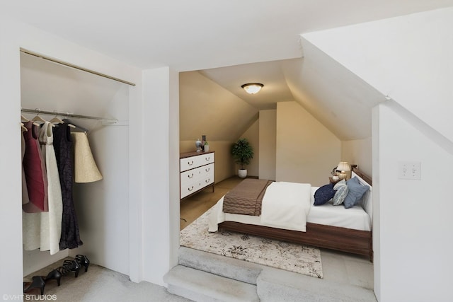 bedroom featuring lofted ceiling and carpet flooring