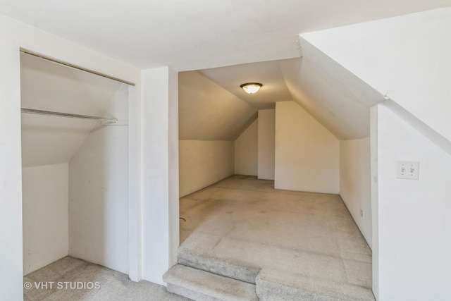 bonus room with carpet floors and vaulted ceiling