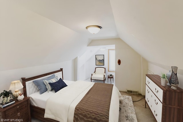 bedroom with carpet floors, visible vents, and vaulted ceiling