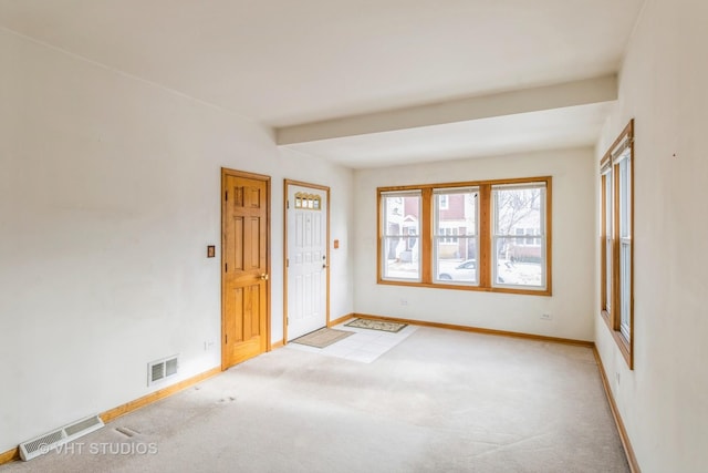 unfurnished room featuring light carpet, baseboards, and visible vents