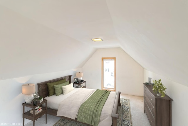 carpeted bedroom featuring lofted ceiling