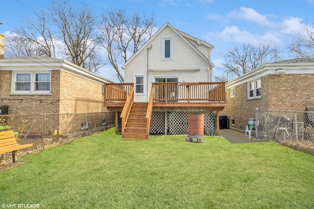 back of property with stairs, a lawn, a deck, and fence