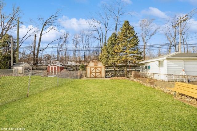 view of yard featuring an outbuilding, a fenced backyard, and a shed