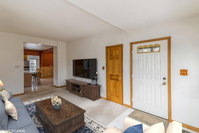 carpeted living area with baseboards