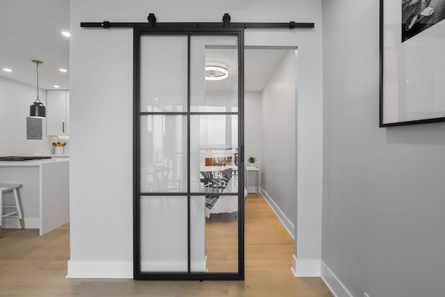 room details with wood-type flooring, electric panel, and a barn door