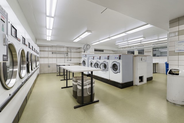 laundry area featuring stacked washing maching and dryer and separate washer and dryer