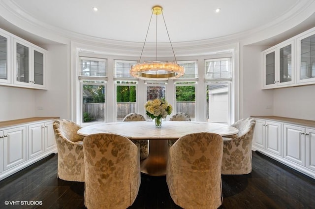 dining space featuring ornamental molding and dark hardwood / wood-style flooring