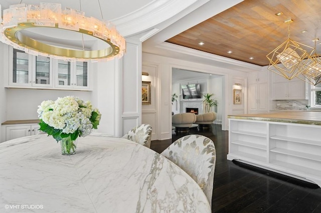 interior space featuring crown molding, wood ceiling, dark hardwood / wood-style floors, and a raised ceiling