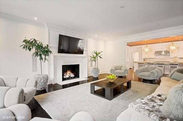 living room featuring crown molding and wood-type flooring