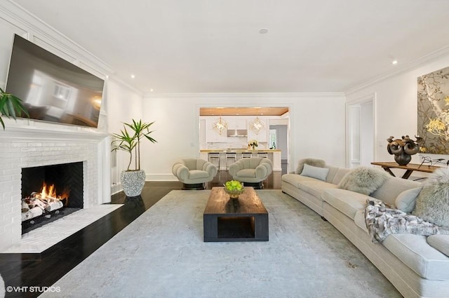 living room with crown molding, a brick fireplace, and wood-type flooring