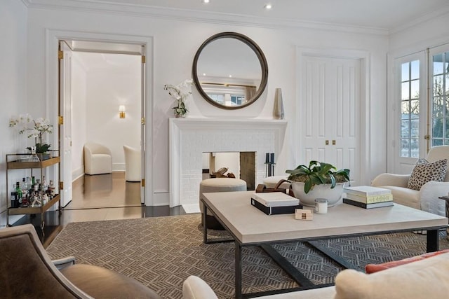 living room with a brick fireplace and crown molding