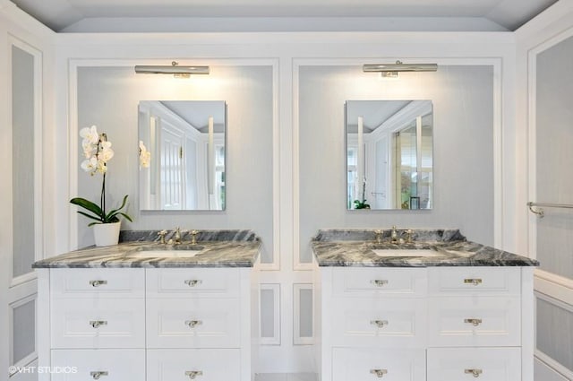 bathroom with vanity and vaulted ceiling