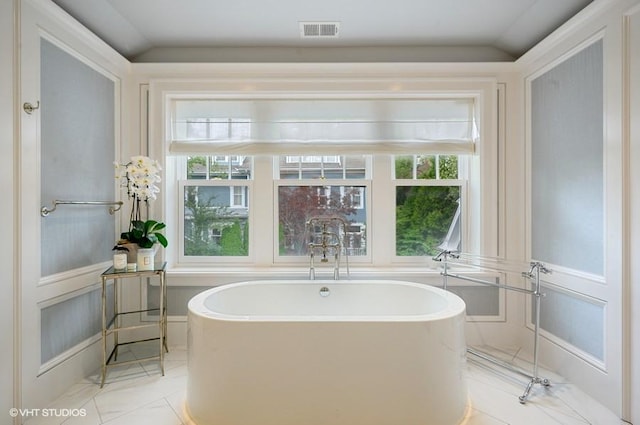 bathroom with a tub to relax in